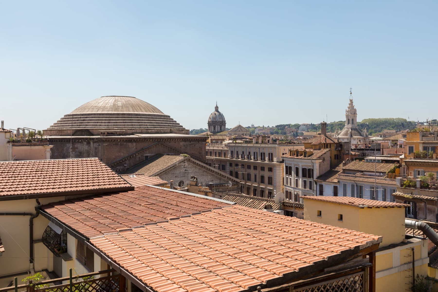 The dome of the Pantheon seen over terracotta rooftops